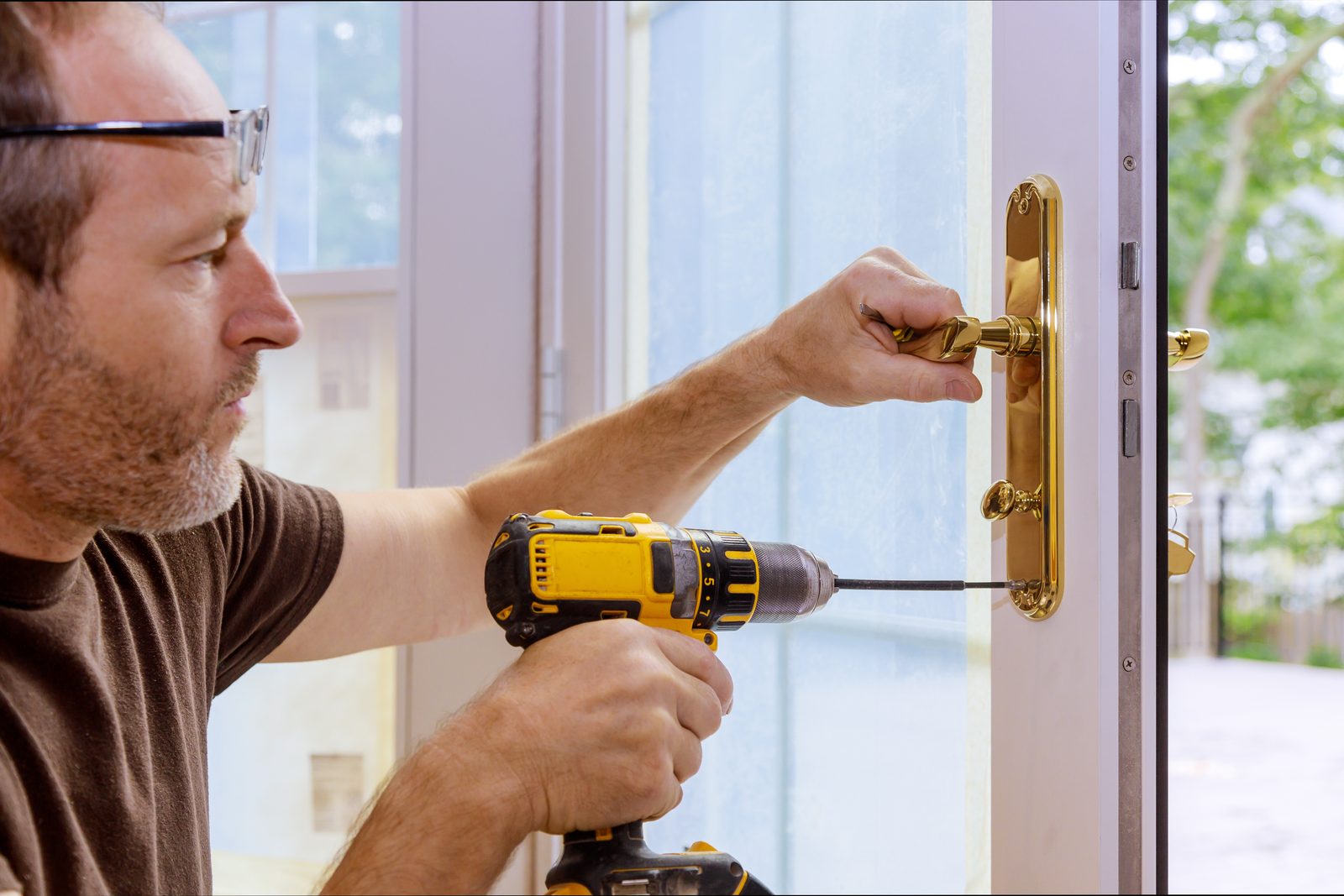 Locksmith repairing a brass door lock in Washington, DC